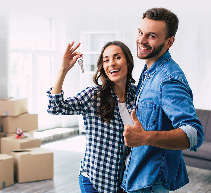 Happy couple with house keys